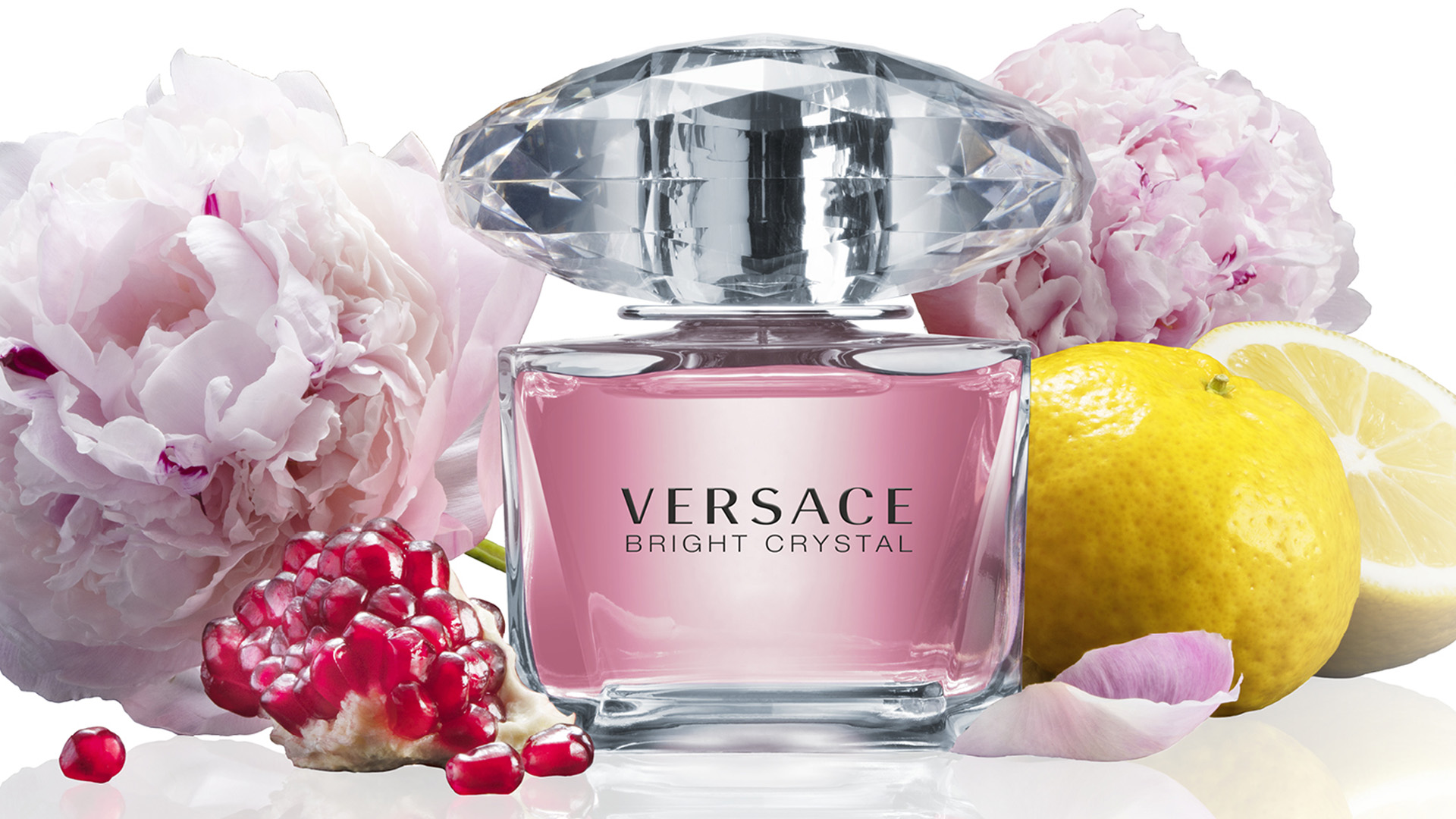 Versace Bright Crystal ingredient image with peonys, lemon, pomegranate seeds.